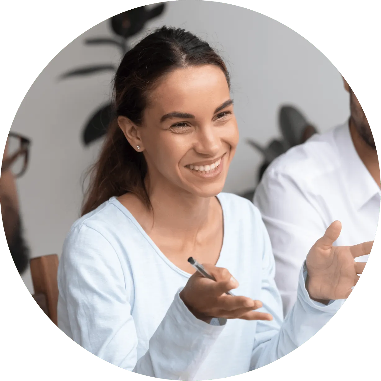 A woman smiling and pointing to the side.